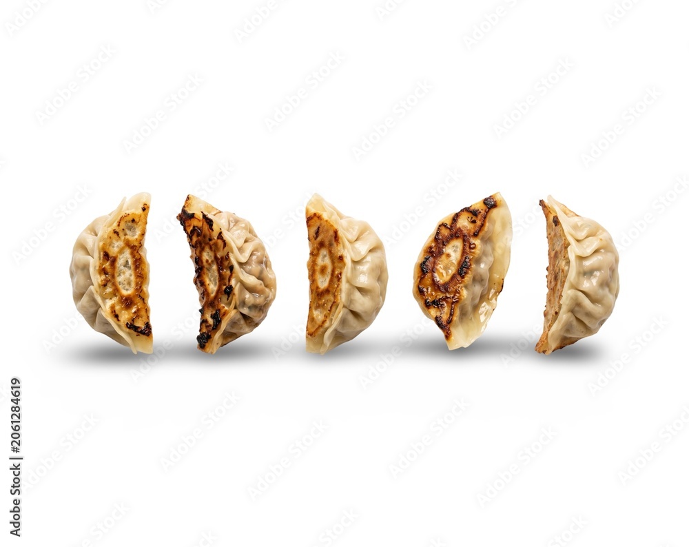 Fototapeta premium Three golden granola energy bars stacked on white background minimalist food photography