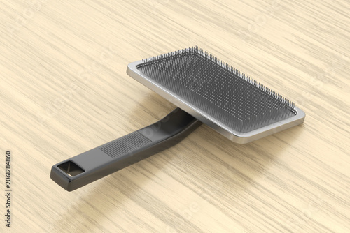 Pet grooming brush on wooden table