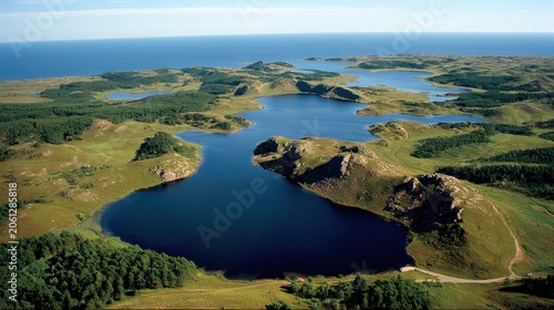 Aerial view of scenic landscape with multiple lakes and distant ocean