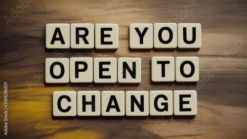 Motivational concept with tiles saying are you open to change