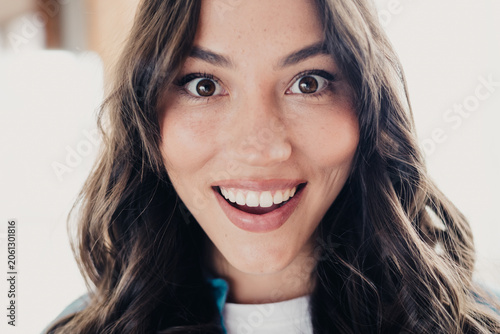 Fotografija Close-up portrait of a happy, surprised woman smiling with bright eyes, long wav