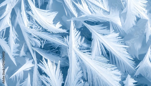 Frozen frost crystals on windowpane surface.