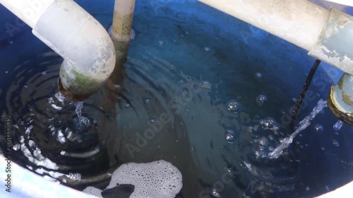 Gentle ripples form on the surface of water inside an aquarium system.