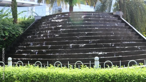 Modern cascading water feature creating a relaxing atmosphere in a landscaped outdoor park.