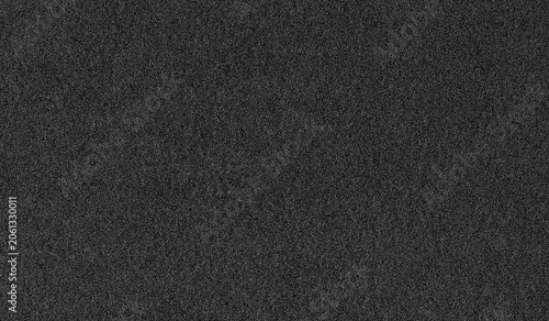 Dark gray grain noise texture background. Distressed grainy surface with monochromatic static effect. Grunge overlay pattern for abstract design projects and digital graphic asset creation