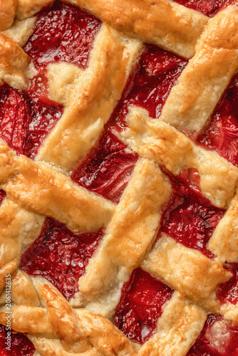 Fresh strawberry lattice pie close up. Summer dessert top view