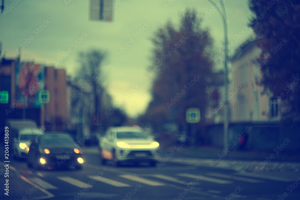 Fototapeta premium Night city blurred background, bokeh in autumn city traffic cars