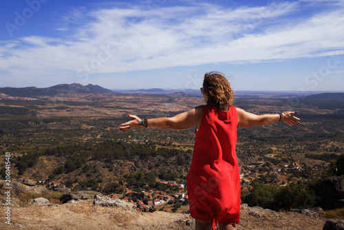 Konstfotografi Female with arms wide open absorbing the beauty of nature