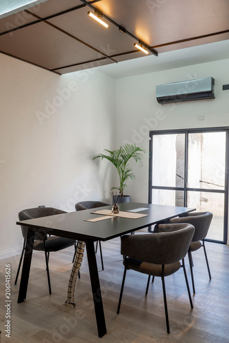 Modern minimalist meeting room interior with track lighting