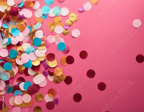 colorful celebration background with party confetti on pink back