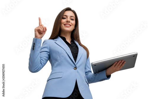 Confident Professional Businesswoman in Blue Suit Pointing Up and Holding Laptop