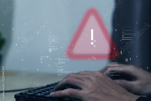 Cybersecurity warning concept with businessman using laptop and digital alert interface, representing data breach, malware attack, online fraud, phishing scam, and network protection technology.