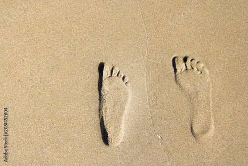 Barefoot footprints in sand, forensic and criminalistics concept, tracks evidence for investigation, beach or desert, crime scene research