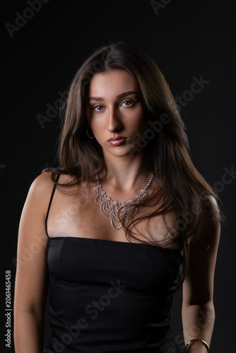 Female model posing in a studio, showcasing beauty, fashion, and glamour