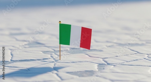 Small flag of italy planted in a cracked frozen icy ground surface