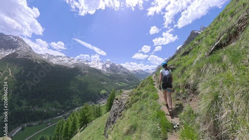 Val di Rhemes, Valle d'Aosta, Italy: A woman walking on a steep path in a wonderful panorama landscape