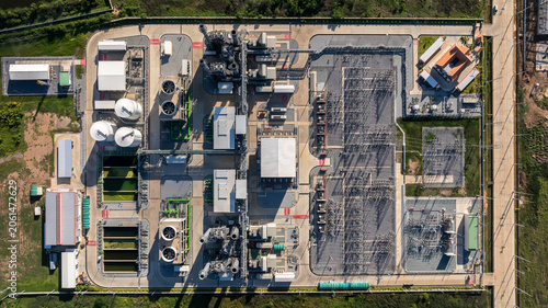 Bild auf Leinwand Aerial view combined cycle power plant with cooling tower and substation under blue sky, Industrial infrastructure of electric power station, exhaust stack and cooling systems