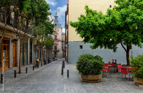 Cozy old street with table of restaurant in Madrid, Spain. Architecture and l...