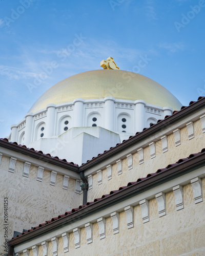 Golden Dome of Mediterranean Style Building Against Blue Sky