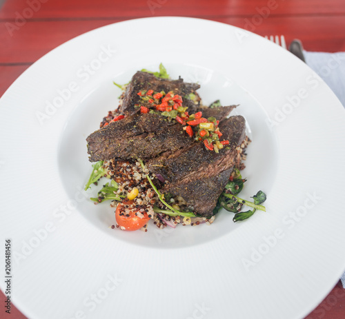 Gourmet Steak Dish with Quinoa Salad on White Plate