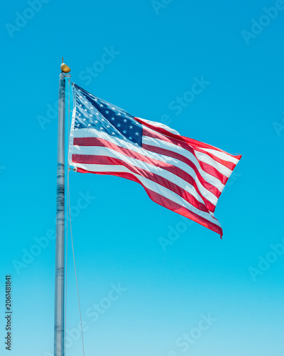 American Flag Waving Against Clear Blue Sky
