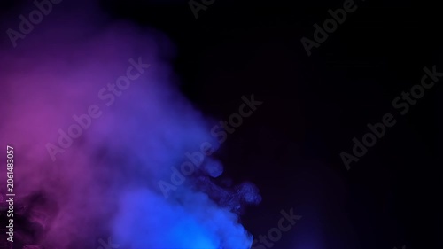 Purple and blue colored smoke swirls in dark background with dramatic lighting effects for creative visual design projects.