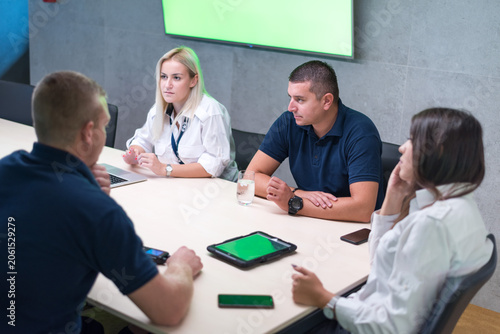 Security Team Meeting in Modern Conference Room with Digital Tablets
