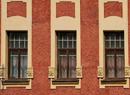 Three large windows on the facade of a modern house