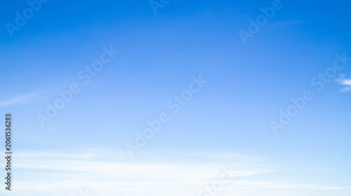фотографія Wide panoramic blue sky with soft white clouds, clean bright sky background with copy space for website header or banner