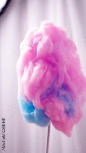 Colorful smoke plume swirling in soft light against haze
