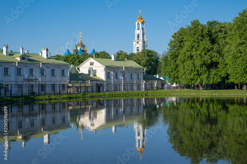 The domes and bell tower of the Holy Trinity Sergius Lavra in the reflection of the White Pond. Sergiev Posad, Moscow region. Golden Ring of Russia