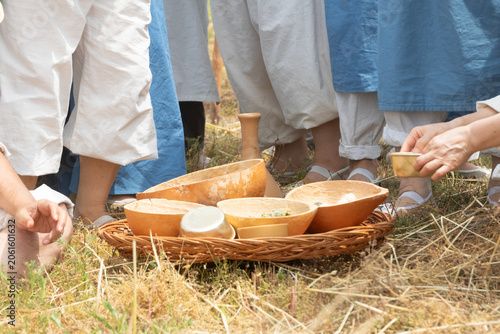 Traditional Korean rural ritual food served in wooden bowls on a basket during an agricultural folk festival reenactment.