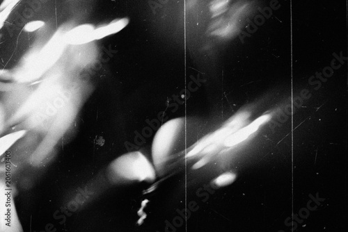 retro film overlay effect with scratch dust and bokeh light leaks,retro grain noisy film distressed light leak flare on black background,black and white abstract background,Abstract old film texture