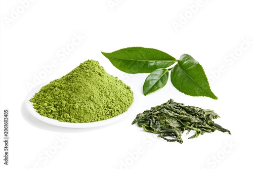 Matcha powder and green tea leaves are displayed on a white background with fresh tea leaves beside them