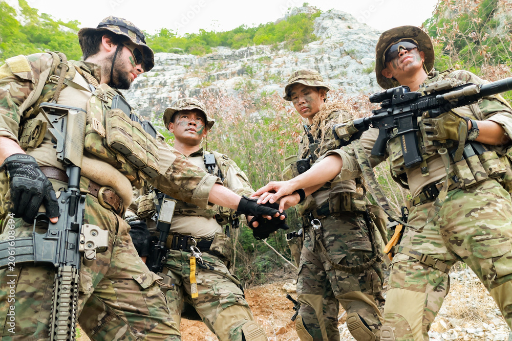 Fototapeta premium Special forces units, armed with war weapons are joining forces in unity surprise attack preparing mission to assault the enemy military.