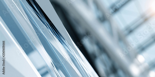 Abstract close-up of modern glass building facade with reflections and geometric patterns, showcasing sleek lines and contemporary architectural design elements