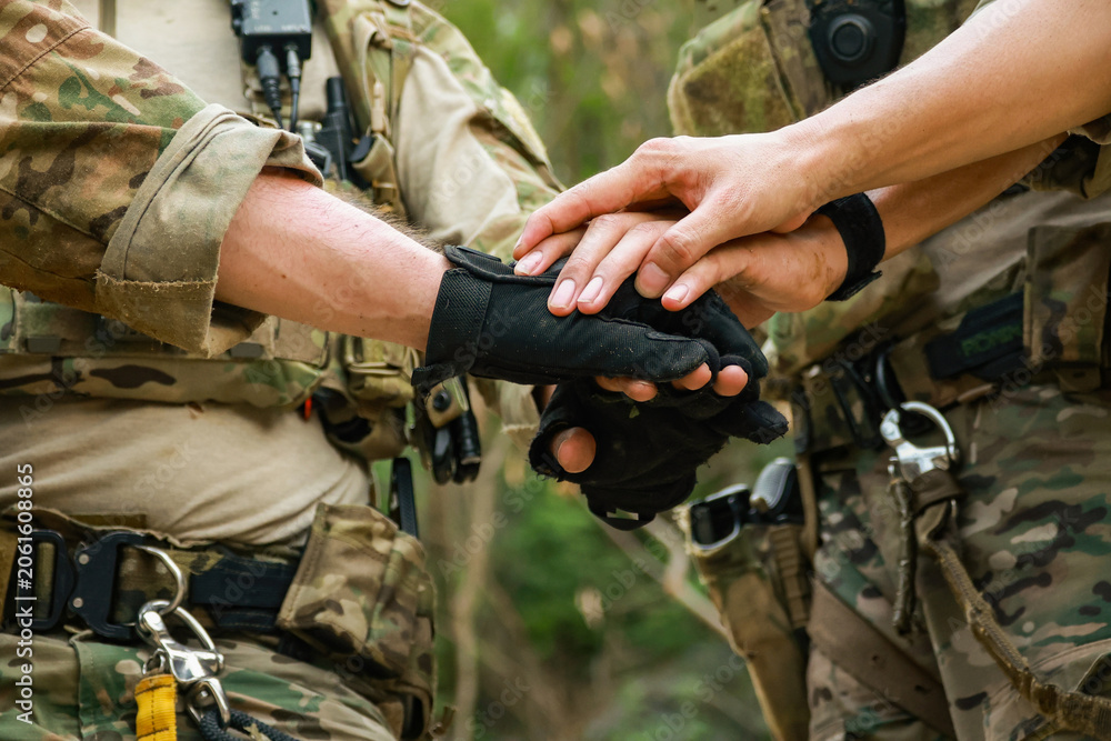 Fototapeta premium Special forces units, armed with war weapons are joining forces in unity surprise attack preparing mission to assault the enemy military.