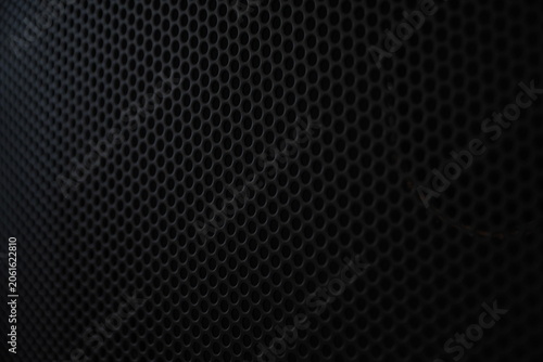 Foto Close-up of black metallic speaker grille texture background