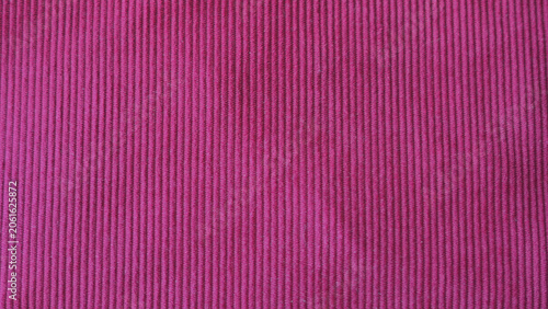 Photography Pink corduroy ribbed fabric texture close up.