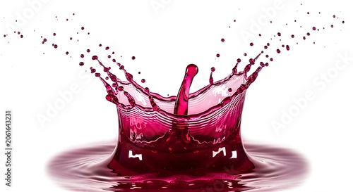 Dramatic high speed photography of crimson liquid splash with droplets and ripples