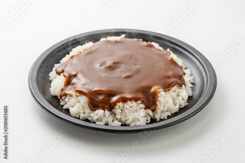 Steaming Japanese curry rice on dark plate