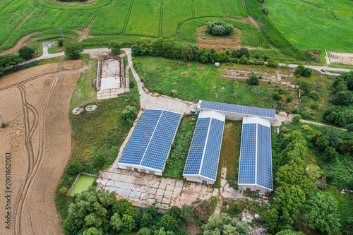 Bird's-eye view of an agricultural building whose roof is fully covered with solar panels