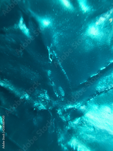 Vibrant turquoise metallic texture background, abstract shiny teal foil surface with crumpled folds and bright iridescent reflections, modern luxury backdrop for creative graphic design assets