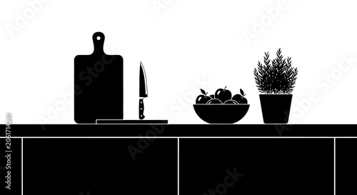 Black and white kitchen island table design features a cutting board, knife, bowl, and potted plant.