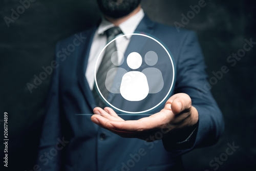 businessman holding a social network icon on a dark background, man and people icon