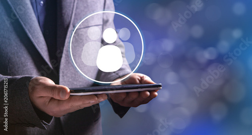 businessman holding a social network icon on a dark background, man and people icon