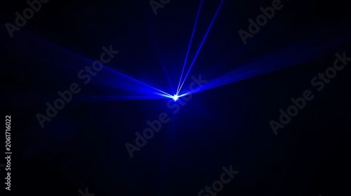 Abstract Blue Laser Light Beam Against Black Background.