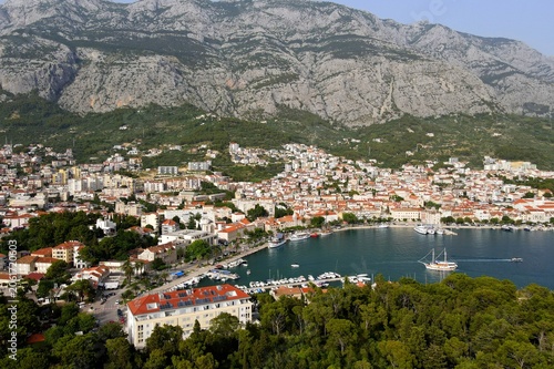 Makarska, Croatia. Coastal town, sea and mountains, Biokovo park. Aerial photography from a drone. Croatian town on the Adriatic Sea. Makarska Riviera