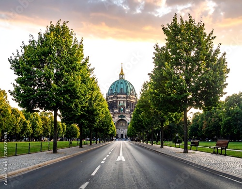 A serene cityscape with a large domed building at the end of a tree-lined road