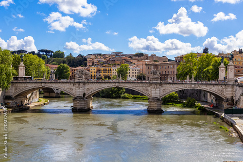 Εκτύπωση καμβά An old stone bridge over the Tiber River in Rome on a sunny day